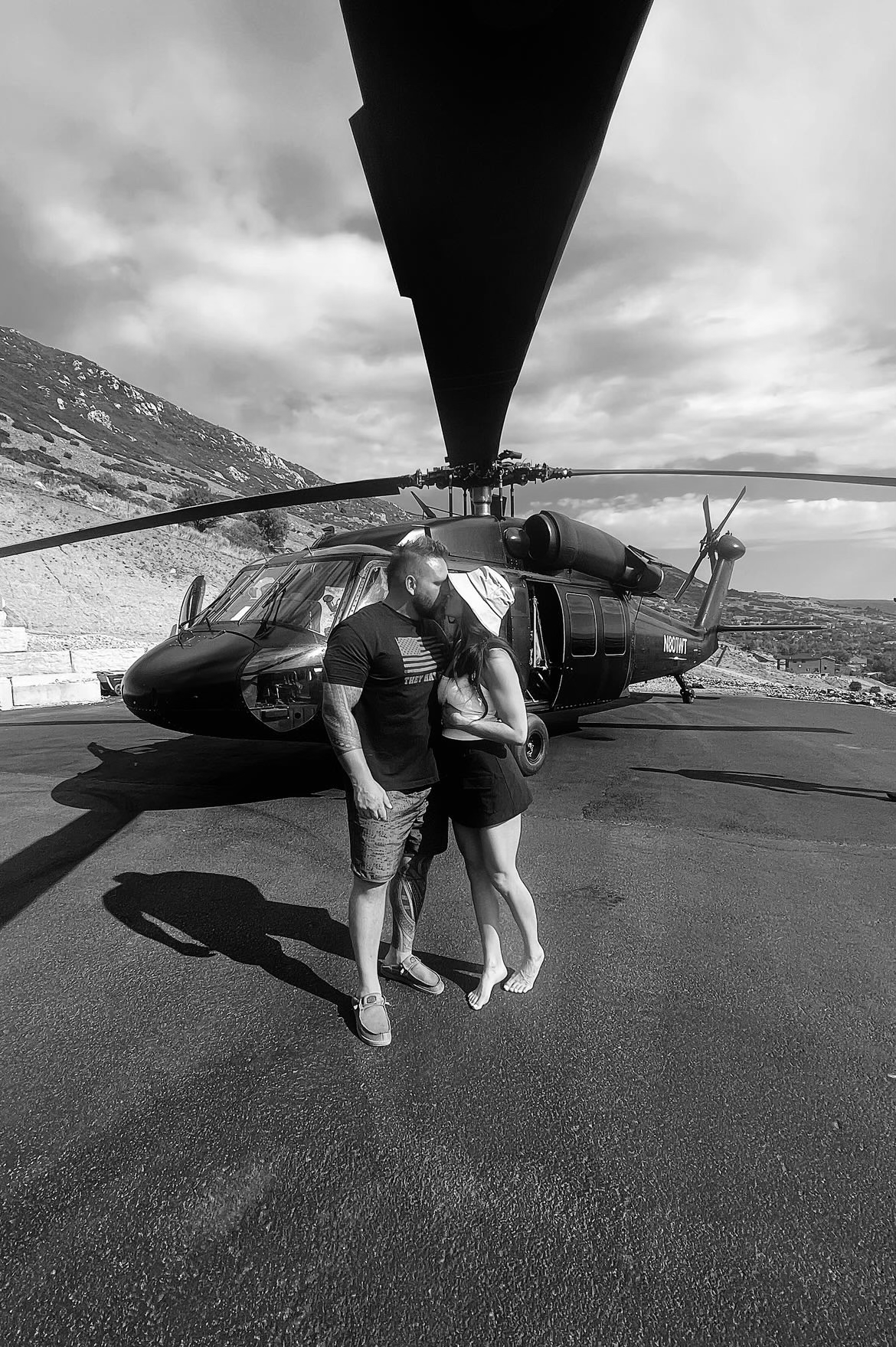 Keaton and his wife in front of a helicopter